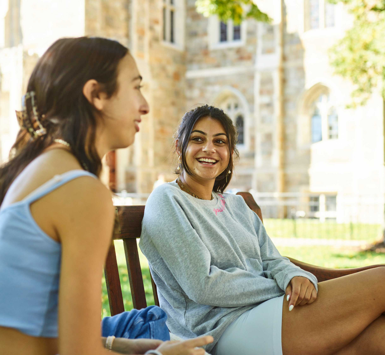 Students talking on a bench on the Boston College campus